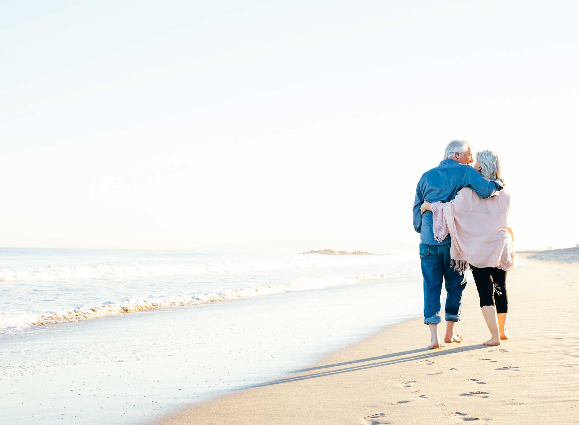 Senior couple walking on the beach